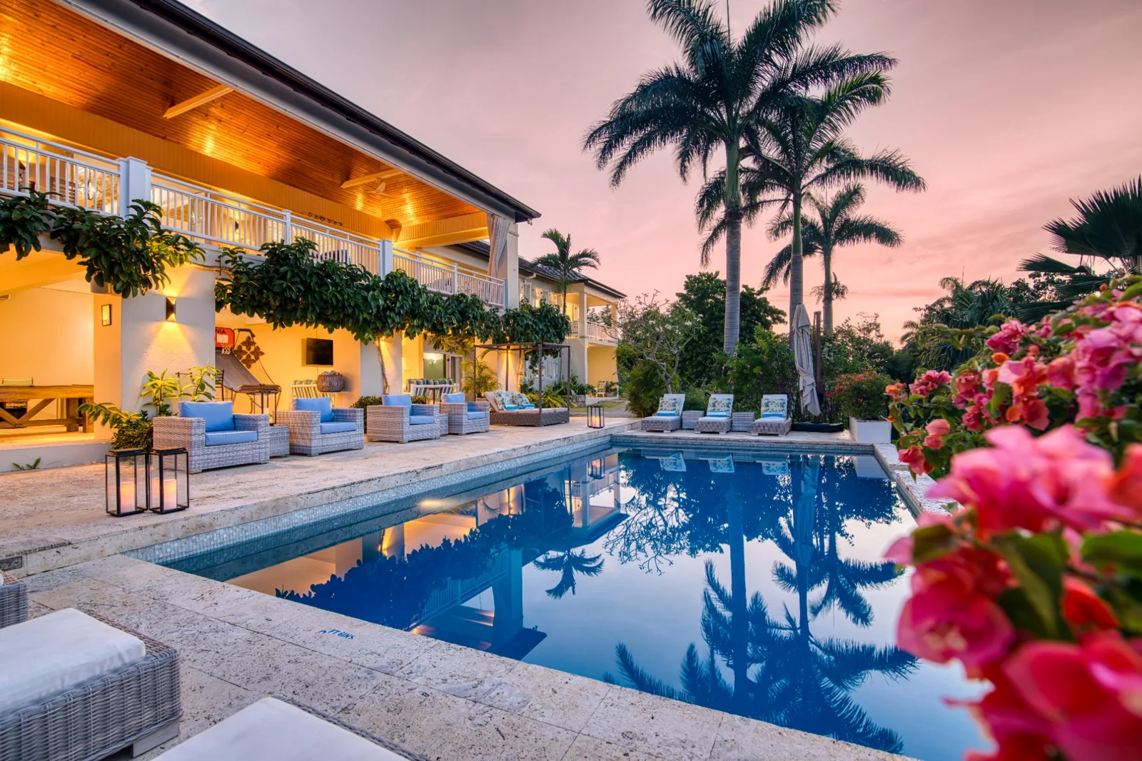 The villa pool and veranda at sunset