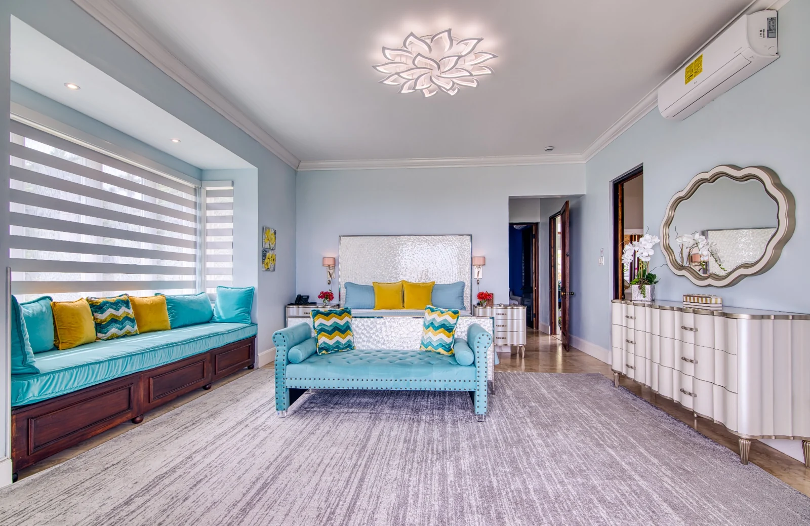 Bedroom with turquoise seating and yellow accents